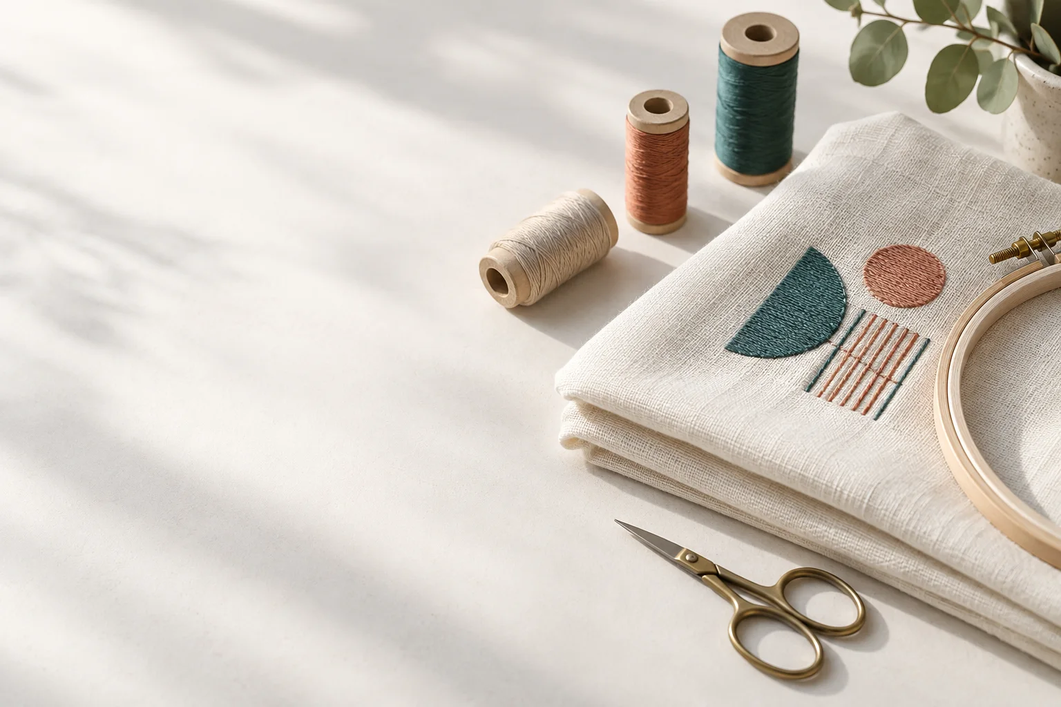 Original illustration of a calm sewing studio with embroidered fabric and thread